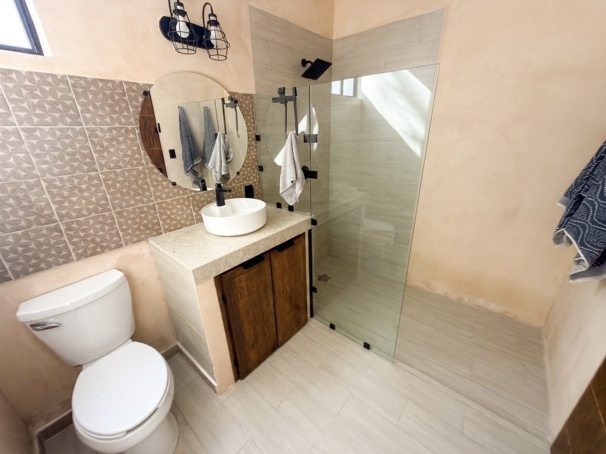 Bathroom with walk-in glass shower and vessel sink