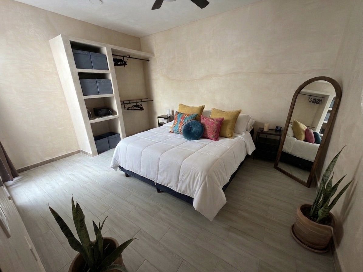 Second bedroom with built-in shelving and wardrobe